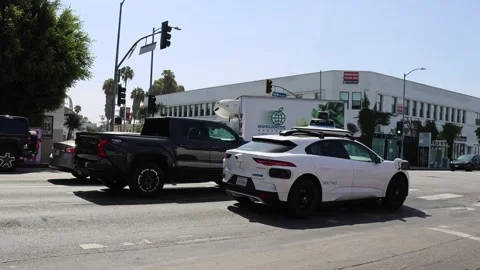 Waymo autonomous self-driving vehicle stopped at a traffic light Stock Footage 340844740