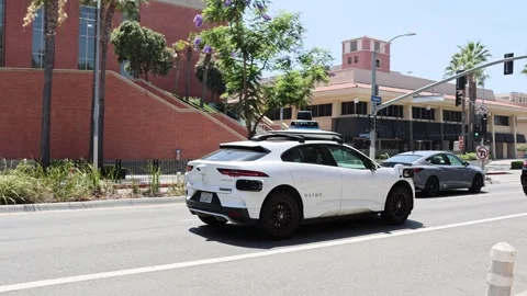 Waymo autonomous self-driving vehicle with driverless seat visible Stock-Footage 340845112