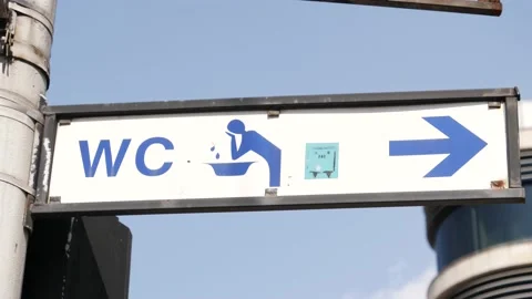 WC street pointer in Wroclaw city center in Poland - lavatory sign arrow Stock Footage 152814239