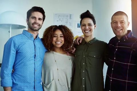 We all show equal commitment. Portrait of a group of businesspeople standing Foto stock