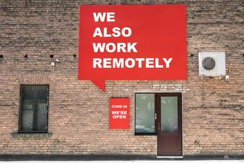 WE ALSO WORK REMOTELY. COME IN WERE OPEN. Advertising banner and information on Stock Photos