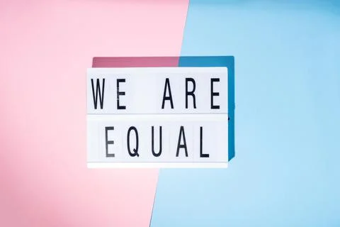 We are equal text on the lightbox. Concept of feminism on a blue and pink Stock Photos