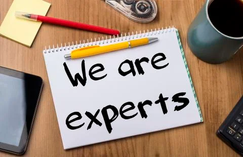 We are experts - Note Pad With Text On Wooden Table Stock Photos