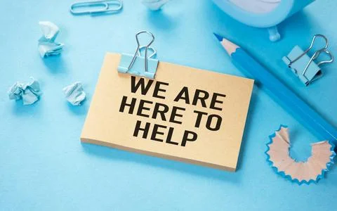 We Are Here To Help open notepad with text on a blue background multi- colo.. Stock Photos