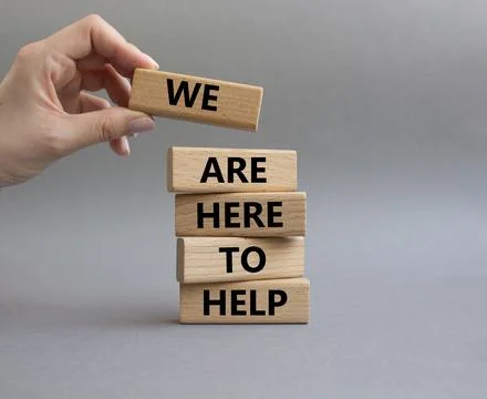 We are here to help symbol. Concept words we are here to help on wooden blo.. Stock Photos