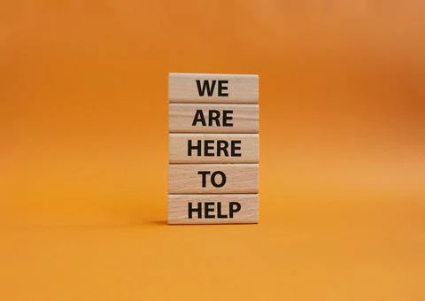 We are here to help symbol. Concept words we are here to help on wooden blo.. Stock Photos