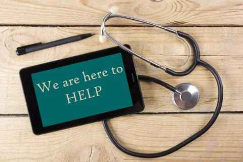 We are here to Help - Workplace of a doctor. Tablet, medical stethoscope, black 库存照片