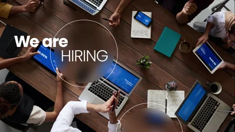 We are hiring, text animation with image of team meeting with laptop in back Stock Footage 243554915