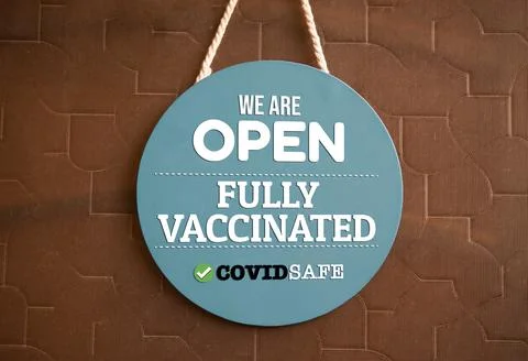 We are open and fully vaccinated sign in shop front Stock Photos