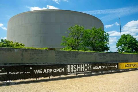 We Are Open banner points to entrance of Hirshhorn Museum Washington DC sun.. Stock Photos