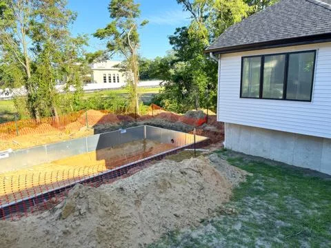 We are in process of constructing steel structure for a swimming pool near house Stock Photos