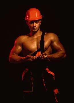 We are solid as steel. Worker or workman in hard hat. Muscular man bend nail Stockfoto's