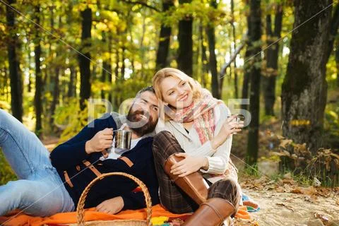 We like autumn time together. Happy couple having fun in autumn park. Stock Photos