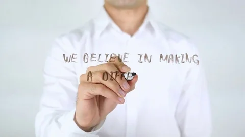 We Believe In Making A Difference, Man Writing on Glass Stock Footage 77830544