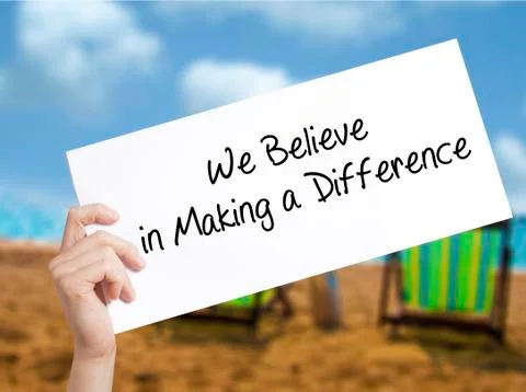 We Believe in Making a Difference Sign on white paper. Man Hand Holding Paper Stock Photos