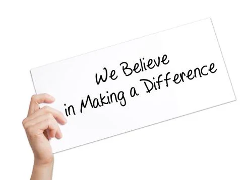 We Believe in Making a Difference Sign on white paper. Man Hand Holding Paper Stock Photos