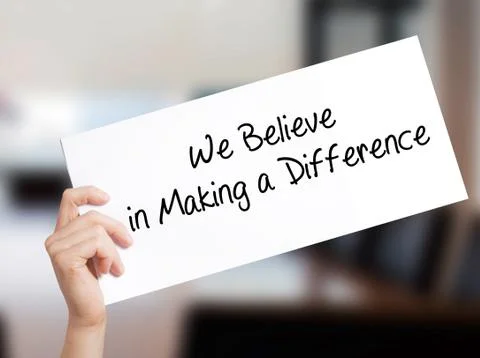 We Believe in Making a Difference Sign on white paper. Man Hand Holding Paper Stock Photos