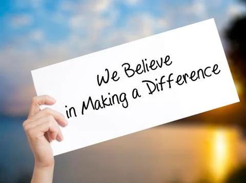 We Believe in Making a Difference Sign on white paper. Man Hand Holding Paper Stock Photos