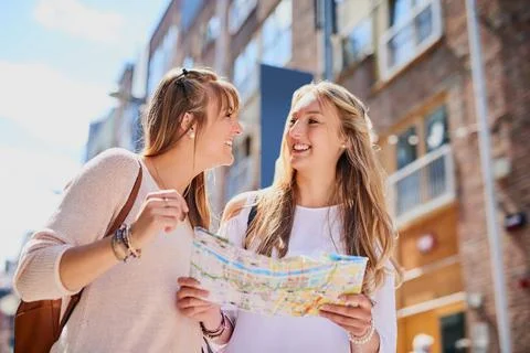 We better not get lost. Low angle shot of two attractive young girlfriends re Fotos de archivo