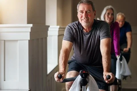 We came to spin and win. a group of seniors having a spinning class at the gym. Stock Photos