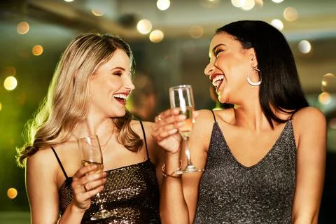 We can be young forever. two cheerful young women having drinks while dancing on Stock Photos