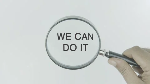 We Can Do It text or word highlighted by a magnifying glass in a hand Stock Footage 303735543