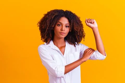 We can do it. Woman's fist of female power. Woman victim of racism. Abuse at  Stock Photos