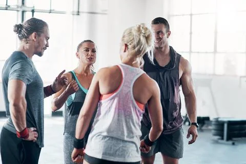 We can do whatever we put our minds to. a group of people chatting at the gym. Fotos de archivo