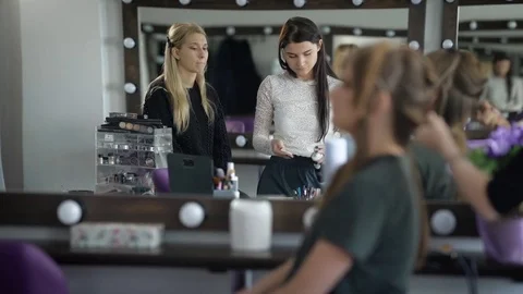 We can see two masters, who do their work in the dressing room. One wipes the Stock Footage