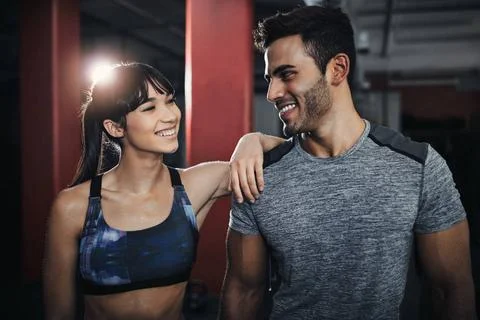 We cannot be our happiest without exercise. two young people at the gym fo... Stock Photos