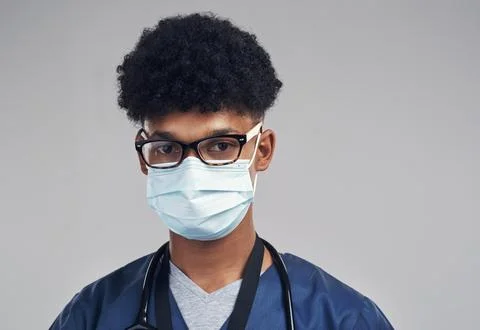 We cant do it alone, we need your help. a male nurse wearing a surgical mask Stock Photos