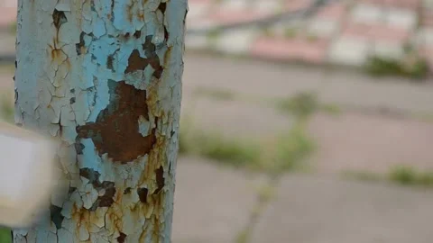 We clean the old paint from the iron pipe with an iron brush. Stock Footage 140579180