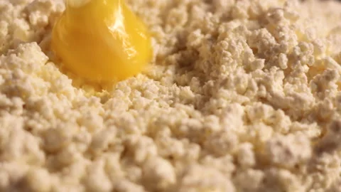 We cook deliciously, raw eggs fall into the curd Stock Footage 166046146