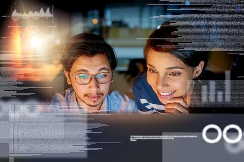We cracking the code. Shot of computer programmers looking through data in th Stock Photos