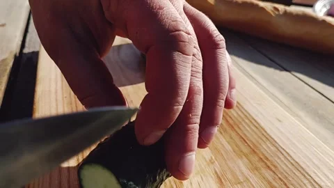 We cut fresh cucumbers for a summer salad Stock-Footage 245991601