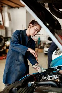We do oil changes, tire rotation, air filter replacement and much more. a female Stock Photos