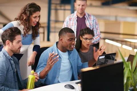 We exceeded our target another month in a row. team of colleagues using a Stock Photos