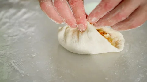 We fasten the edges of homemade cabbage pies with our own hands Stock Footage 320636230