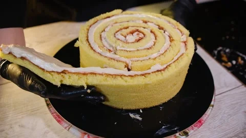 We form a sponge cake with cream into a cake Stock Footage 194737566