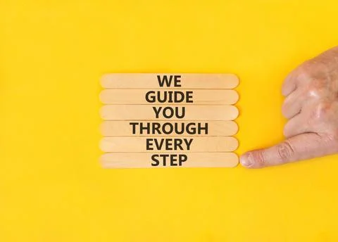 We guide you through every step symbol. Concept words We guide you through .. Stockfoto's