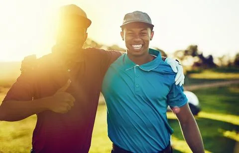 We had so much fun playing golf together. two friends standing together on a Stock Photos