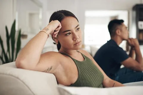We keep fighting about the same thing over and over. a young woman looking upset Stock Photos