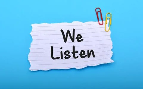 We Listen client services on paper closeup Foto stock