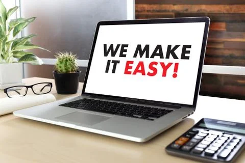 WE MAKE IT EASY! Business team hands at work with financial reports and a lap Foto stock