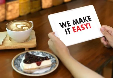 WE MAKE IT EASY! Business team hands at work with financial reports and a lap Foto stock