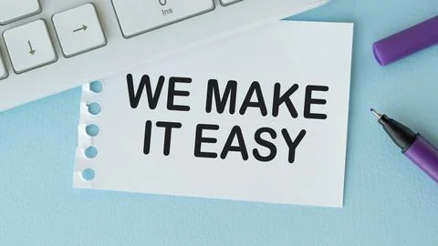 We make it easy text in the notebook on a blue table. Top view - business c.. Stock Photos