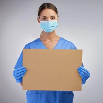 We need all the support we can get. a female nurse holding a board for signage Stock Photos