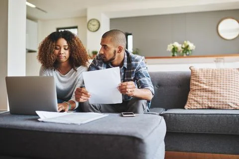 We need to go over these finances. Cropped shot of a stressed young couple Fotos Stock