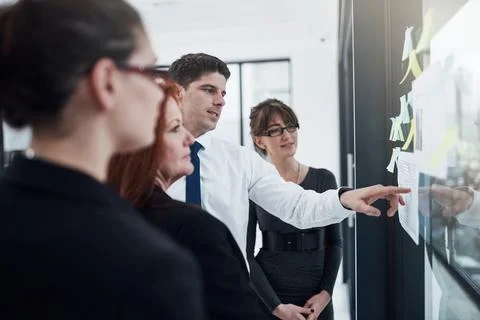We need to priorities this task. a group of businesspeople brainstorming with Stock Photos