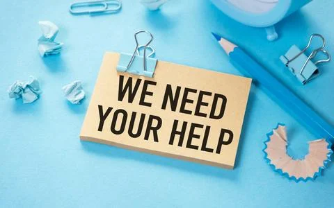 We Need Your Help text on white sticky note on blue background. Foto stock
